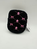 Black textured travel pouch with pink embroidered skulls and bows