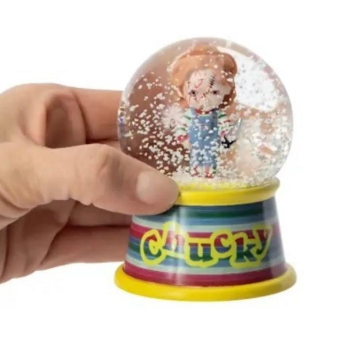 Chucky mini snow globe held in one hand to show its small size