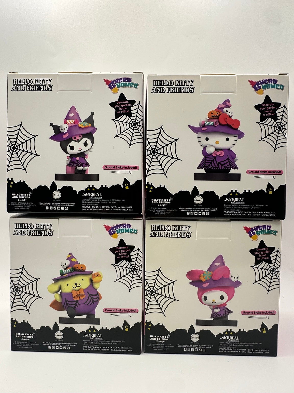 Backs of all four Hello Kitty and Friends Halloween Nerd Gnomes boxes showing characters and included ground stakes