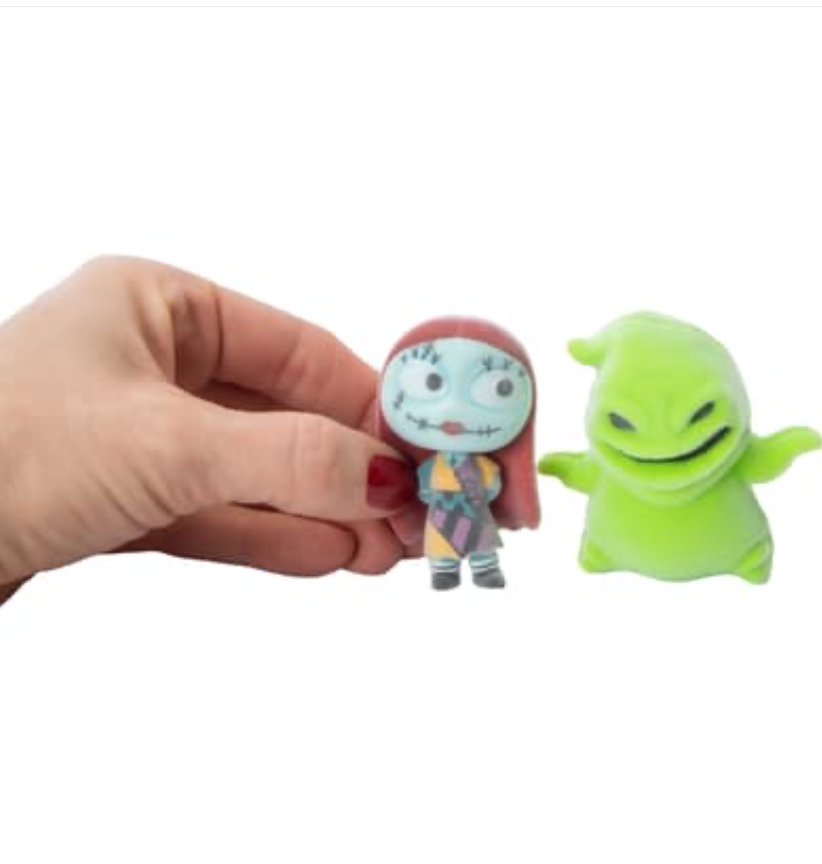 Hand holding Sally flocked figure next to Oogie Boogie showing scale size comparison