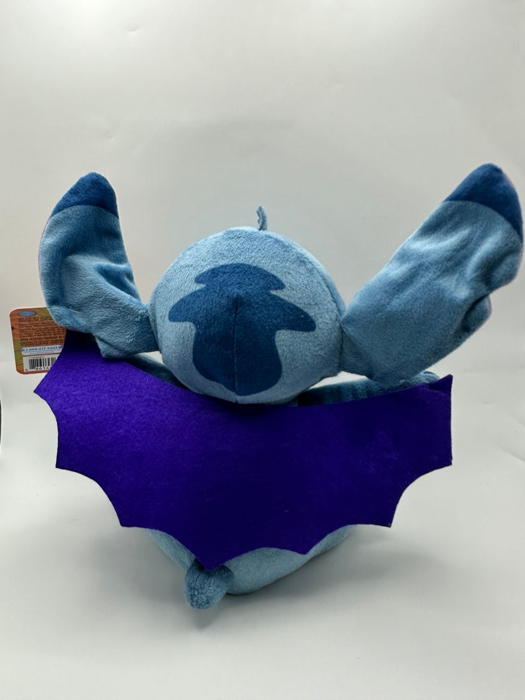Back of the included vampire Stitch plush showing the purple cape