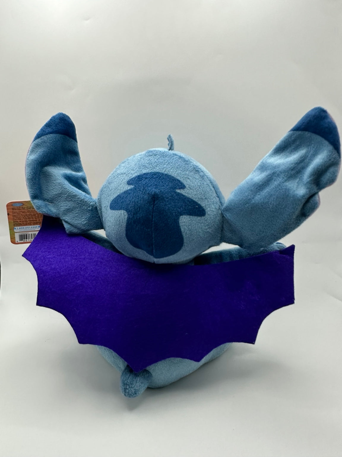Back of the included vampire Stitch plush showing the purple cape