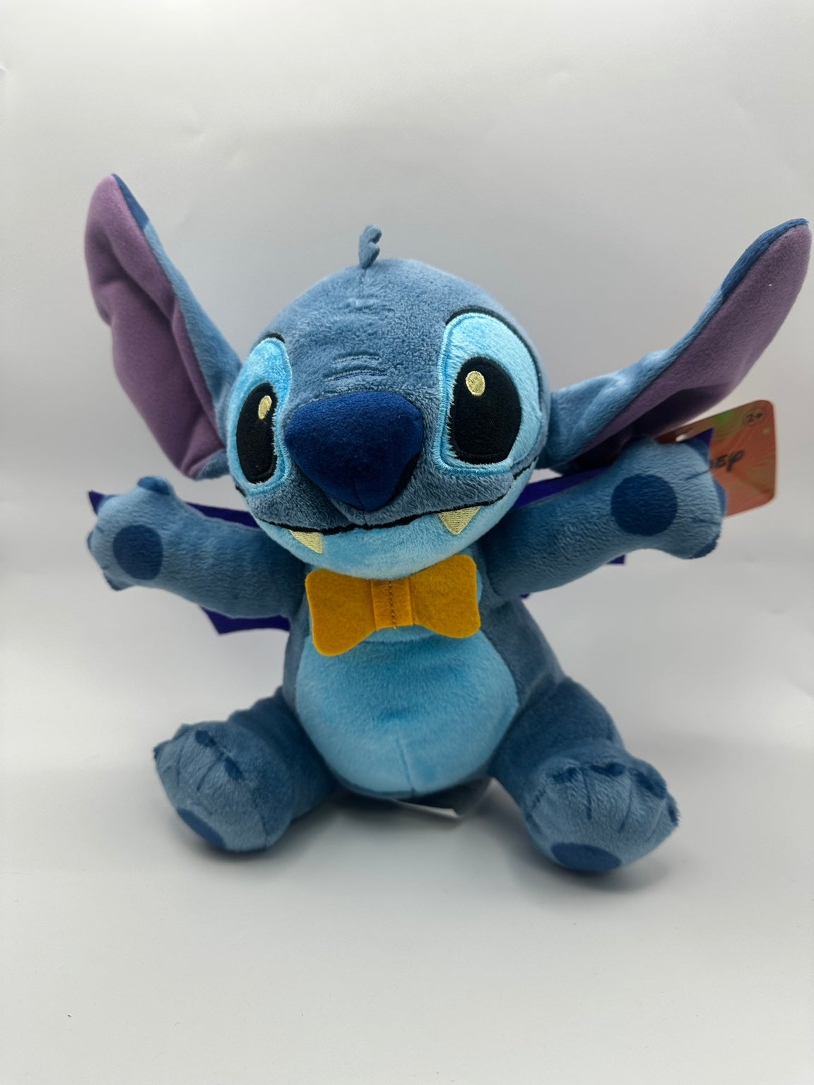Included vampire Stitch plush with yellow bow tie, fangs and purple cape