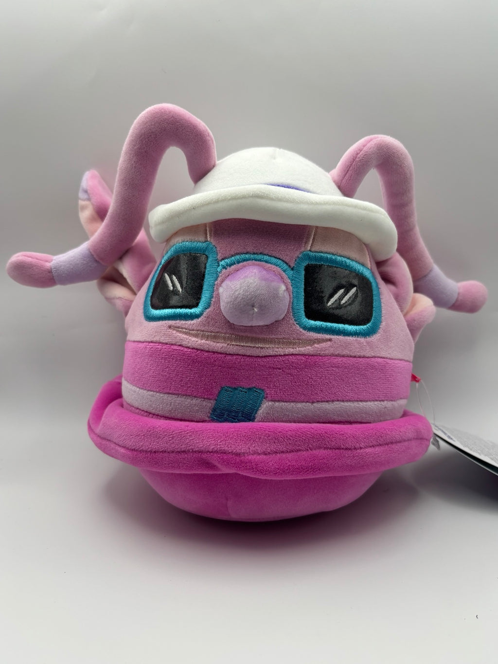 Disney Angel Squishmallows plush with white sun hat and turquoise sunglasses, front view