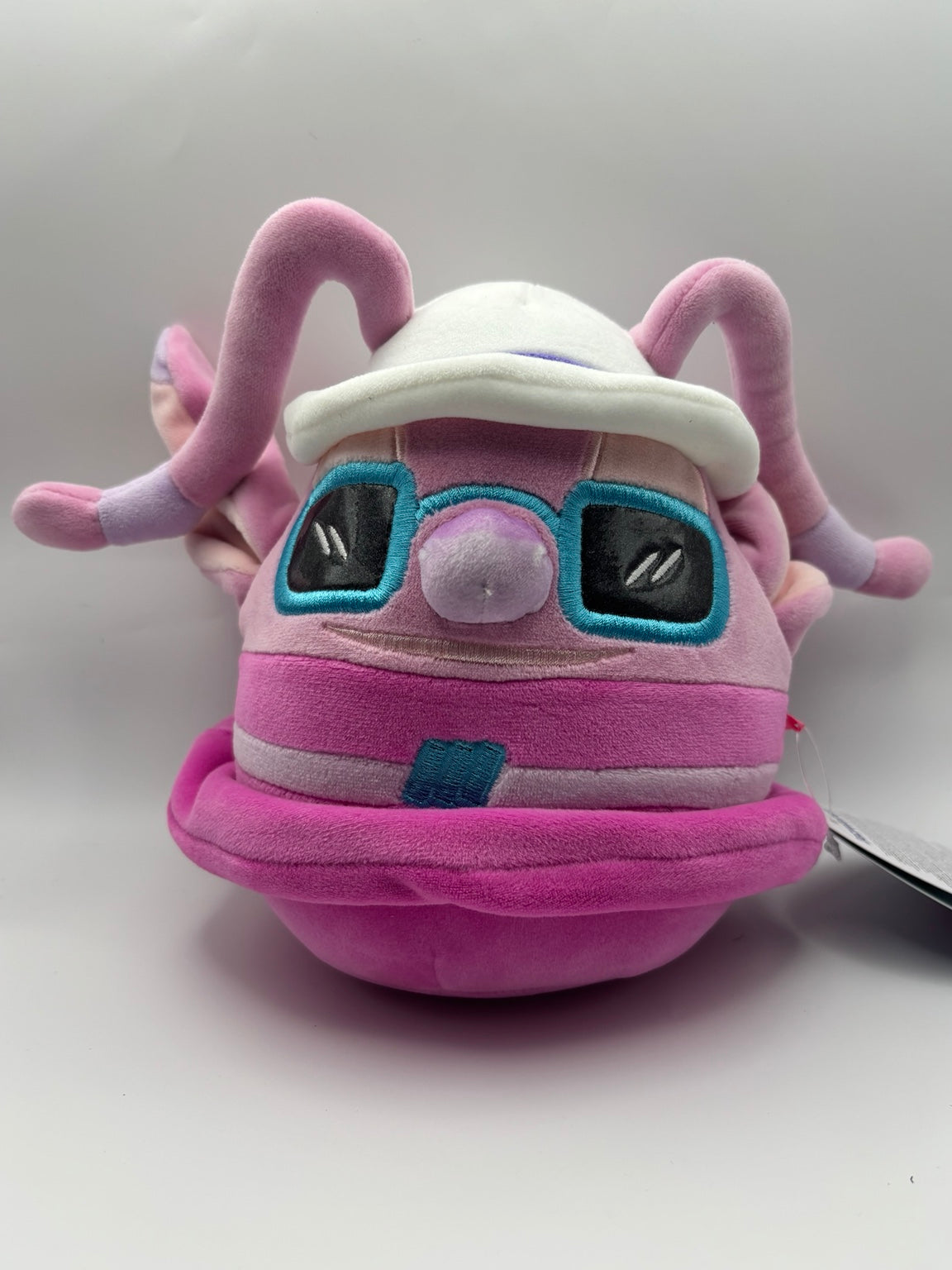 Disney Angel Squishmallows plush with white sun hat and turquoise sunglasses, front view