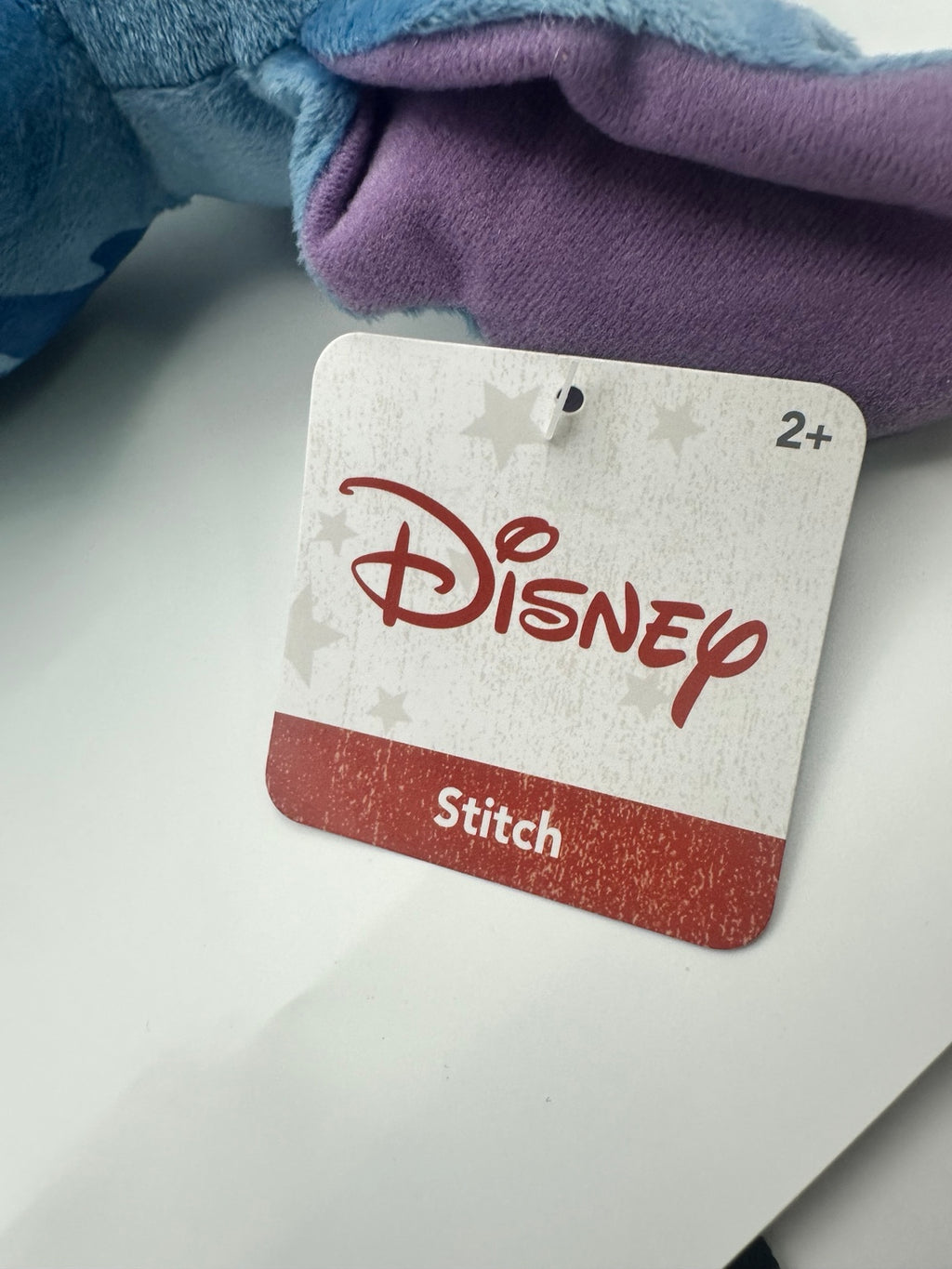 Disney Stitch tag on the included patriotic sunglasses plush