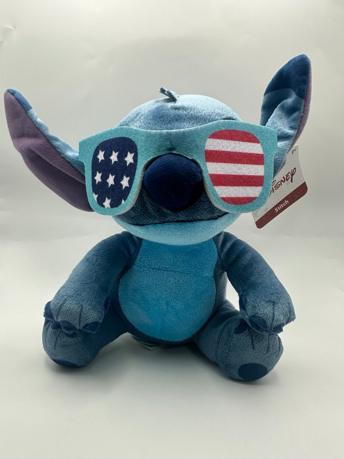 Included Stitch plush wearing American flag sunglasses